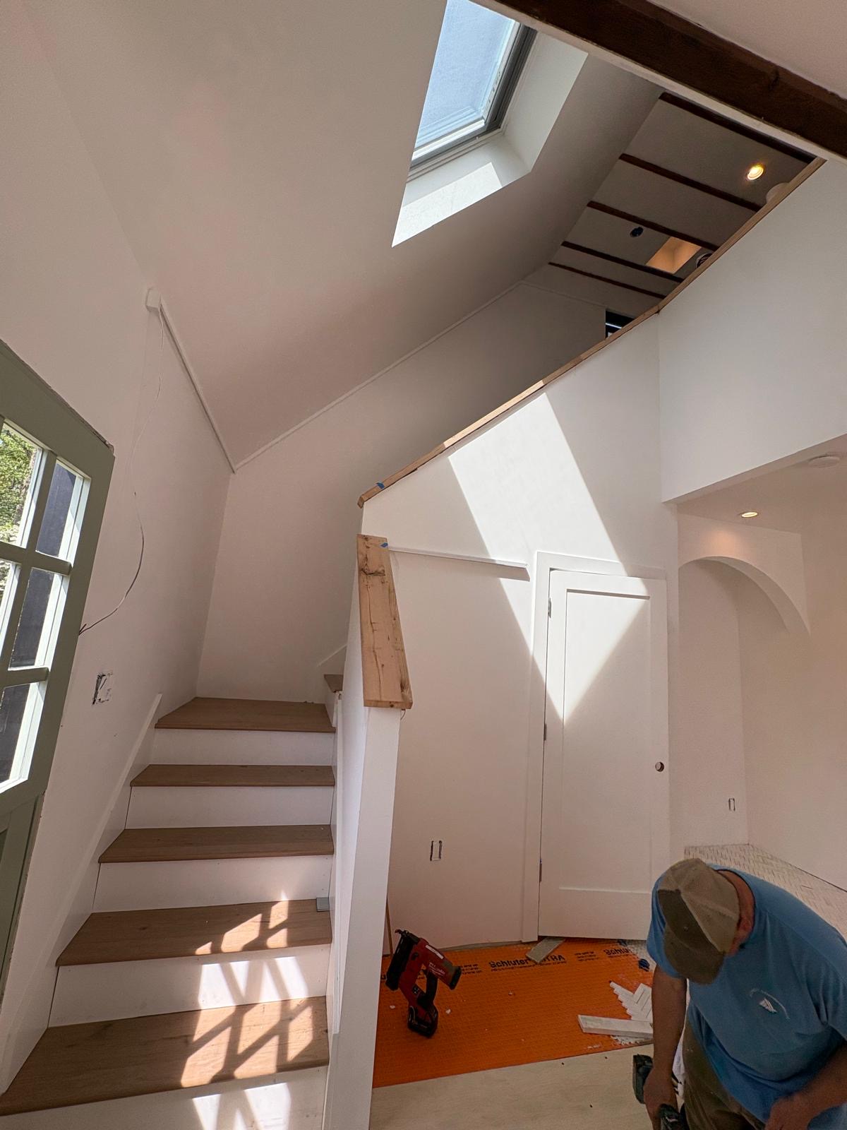 Staircase with skylight and exposed beams